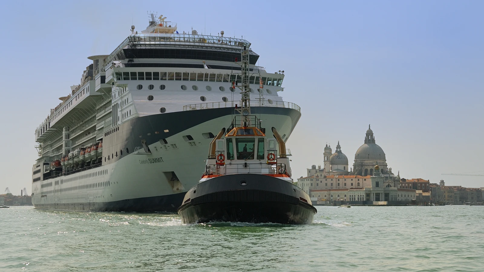 Celebrity Summit cruise ship leaving Venice with a tugboat
