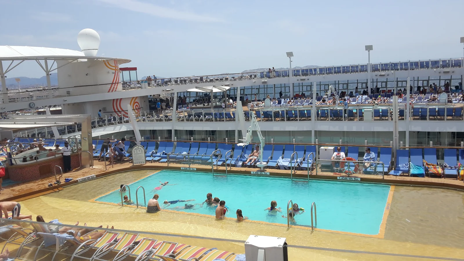 Families using the pool deck on a Royal Caribbean ship