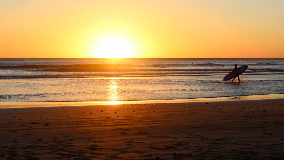 Pacific beach and surfer at San Juan del Sur in Nicaragua