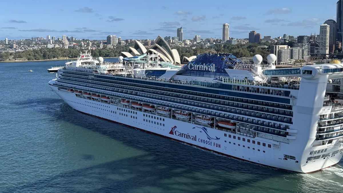 Carnival Adventure cruise ship leaving Sydney in current Carnival livery