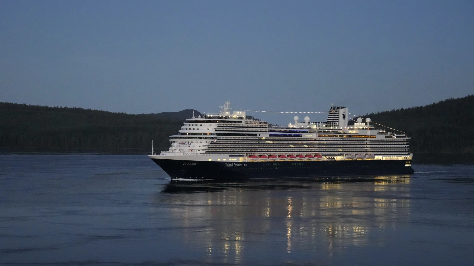 Koningsdam Holland America cruise ship sailing at dusk